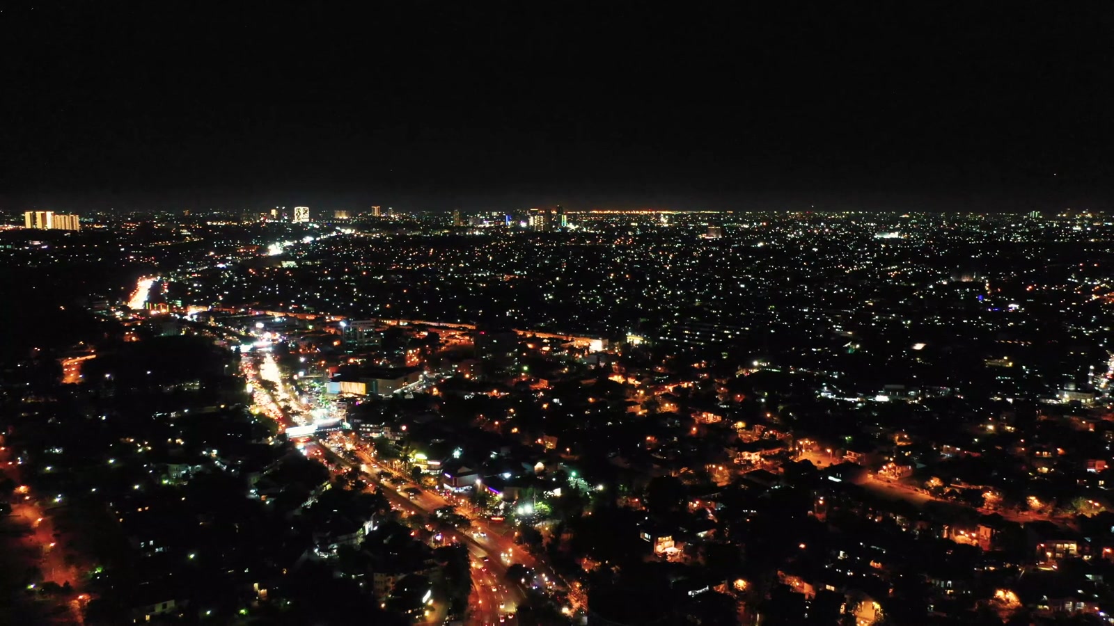 A city’s buildings and infrastructure at night.
