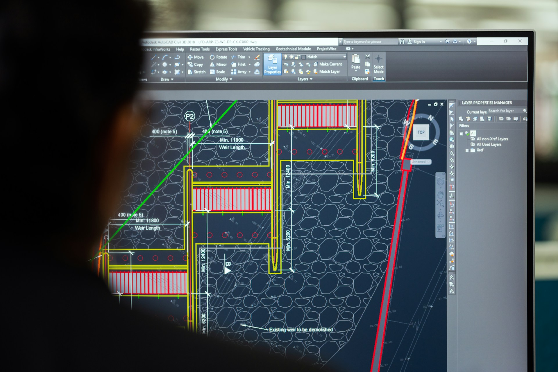 Civil engineering drawings displayed on a workstation monitor.