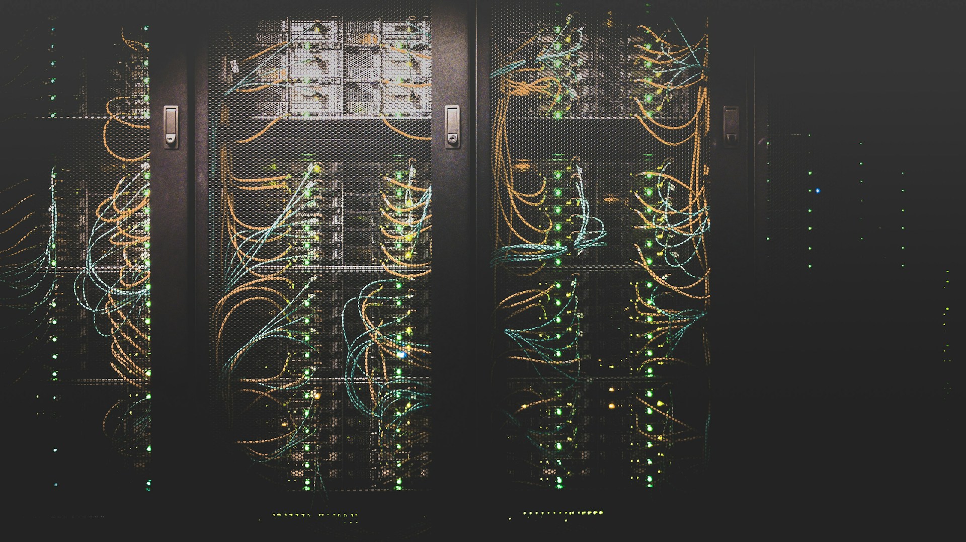 Network cables connect racks of computing equipment.